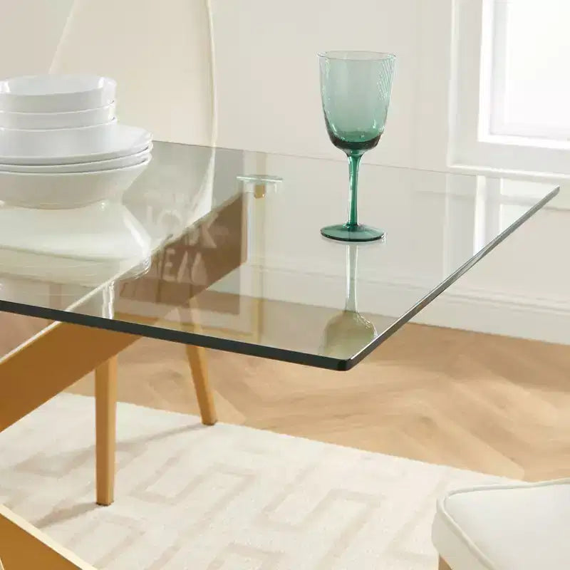 Table de salle à manger avec plateau en verre et pieds en acier