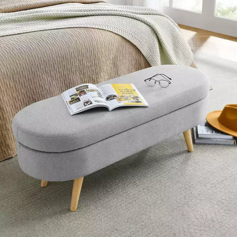 Banc de rangement ottoman ovale en tissu avec pieds en bois d'hévéa